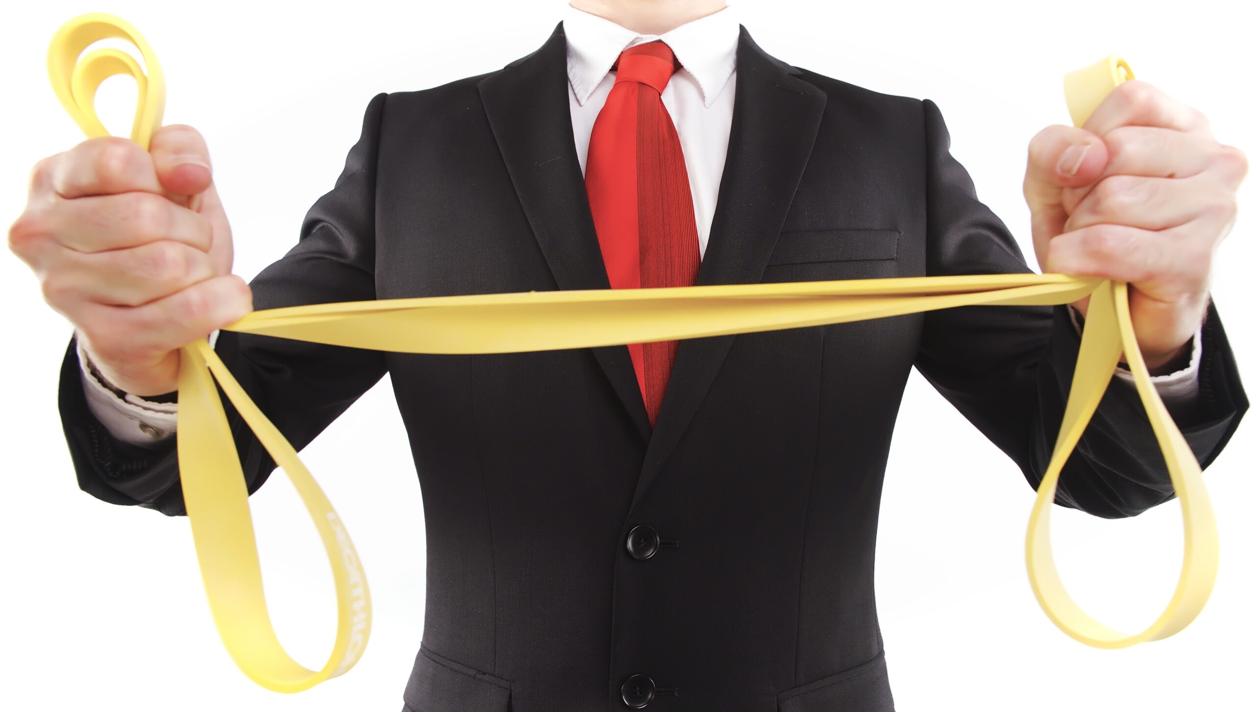 Headless businessman stretching rubber band